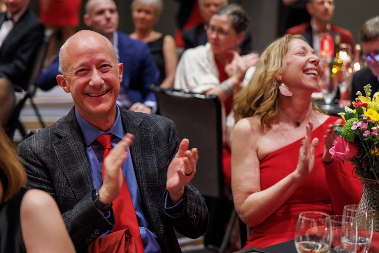 Jennifer and Lance Harlan smiling and clapping